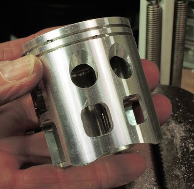 Max's piston with lower holes and notch.