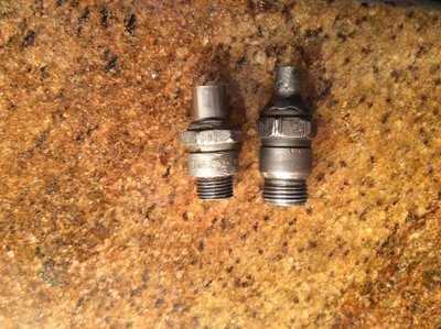 Spark plug bodies are oriented threads upward