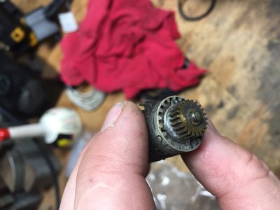 Here you can see the brass drive gear at the end will simply slide off the opposite end. It engages into the recess of the white wheel